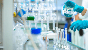 Pouring liquid into test tubes in a professional drug testing laboratory